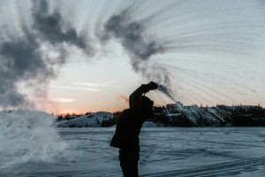 Boiling water freezing instantly in the arctic winter.